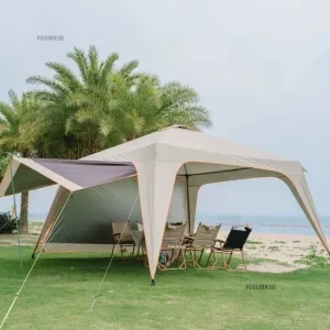 Spacious camping gazebo set up on grass near beach with chairs underneath