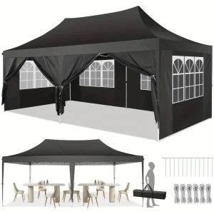 Black camping gazebo with side walls and windows, set up for outdoor dining.
