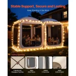 Camping gazebo with family enjoying dinner under string lights at night