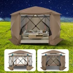 Camping gazebo set up in a grassy area with a cozy seating arrangement inside